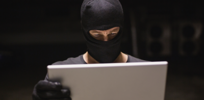Identity theft with gloves and laptop